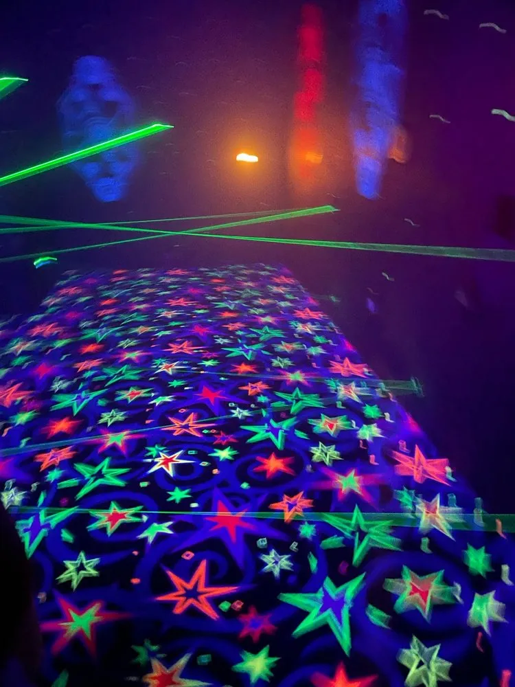 Neon-lit laser tag arena at SacTag for youth group events.